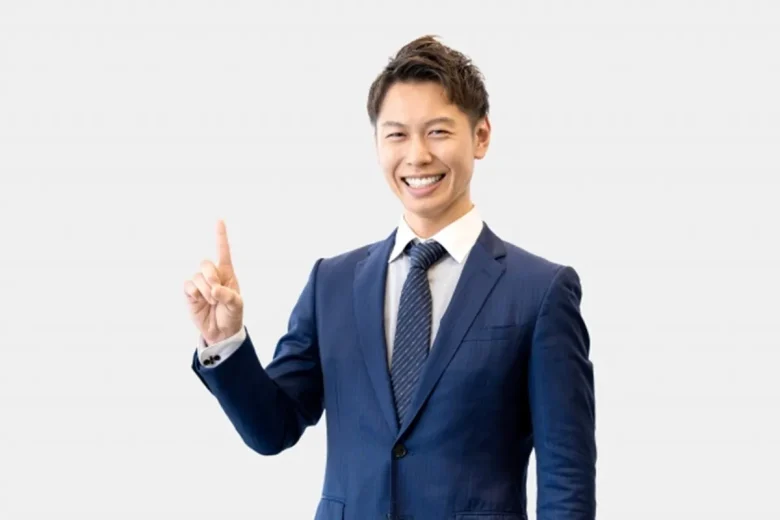 人差し指を立てて案内する男性ビジネスマン